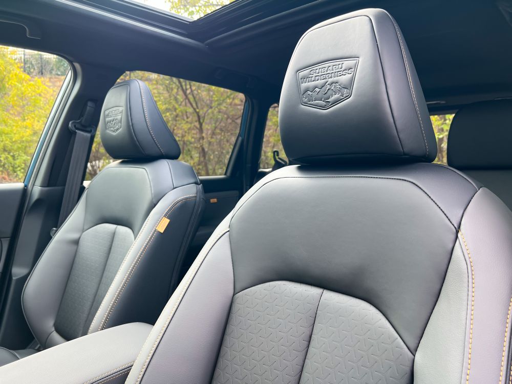 Interior shot looking back from the driver’s door, showing the headrests with “Subaru Wilderness” embossed on them.