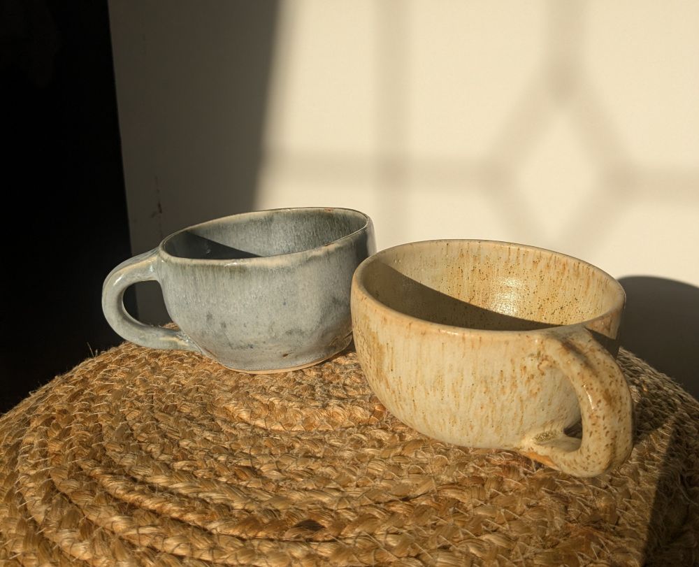 Two mugs: 1 blue-ish, 1 yellow-ish