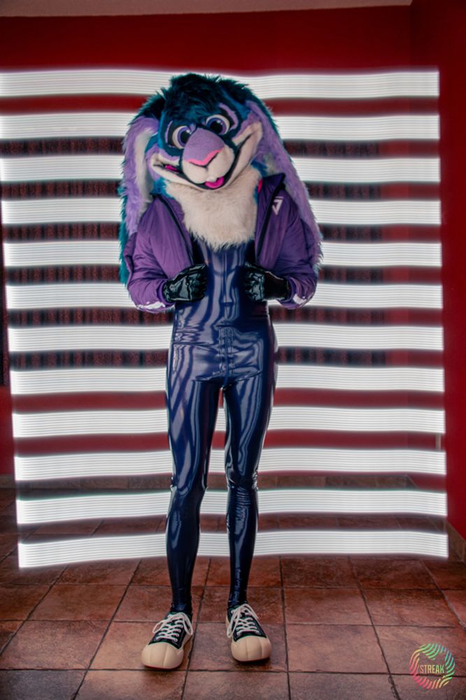 Me wearing my metallic purple Libidex catsuit with Bugs Bunny shoes from BBIMP. The long exposure adds light streaks behind me. 
