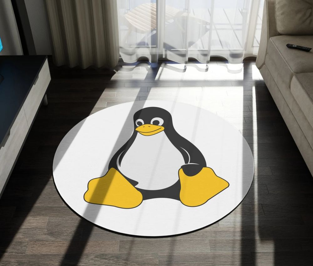 a white circular rug with tux, the linux mascot, on it. it looks very silly compared to the rest of the normal looking furniture