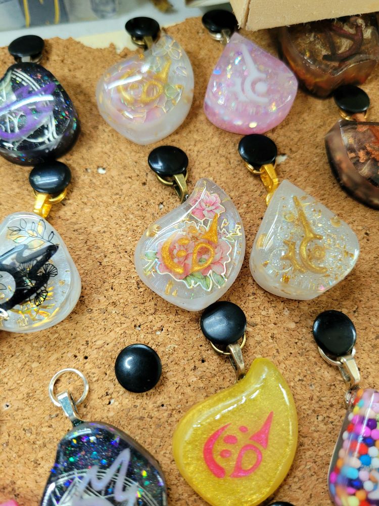 A handful of job stones pinned to a corkboard with a rose themed pictomancer at the center
