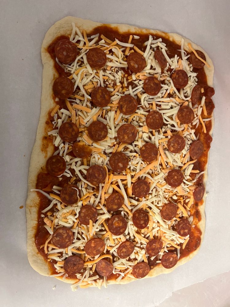 square pizza with tomato sauce, cheese, and chorizo 