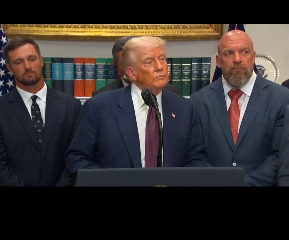 Paul Levesque of WWE/TKO standing beside Donald Trump as Trump lies about his relationship with Jeffrey Epstein 