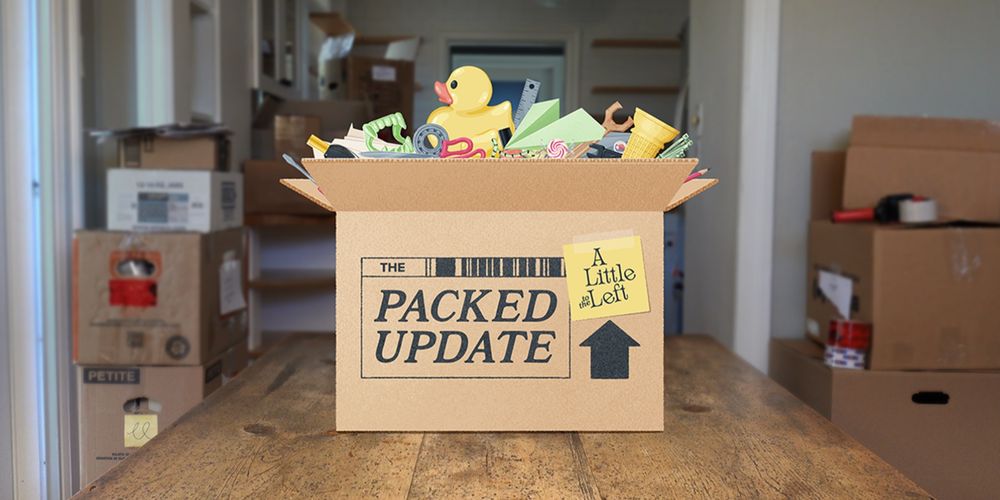 a cartoon cardboard box filled with household objects sits on a table, the background shows an empty house with other packed boxes stacked, the side of the box says "The Packed Update - A Little to the left"