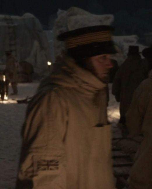 matthew mcnulty as edward little in episode 6 of the terror (2018), bundled up in a large coat and officer's cap