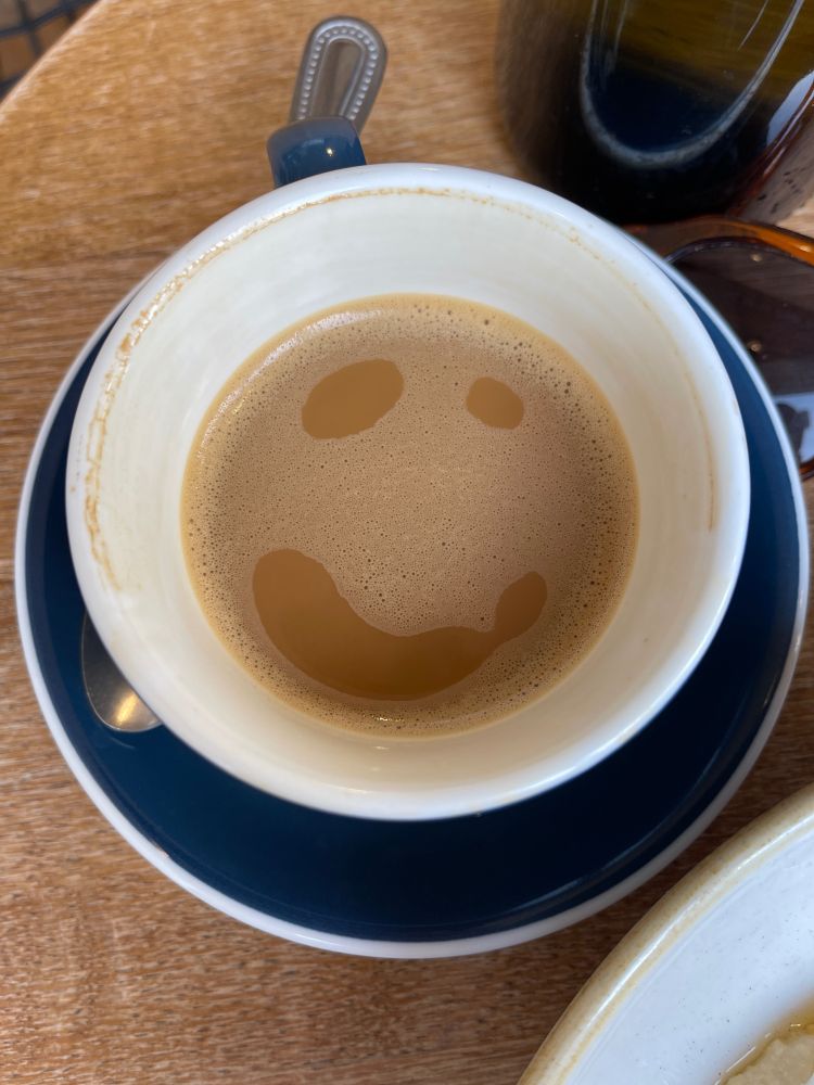 A flat white with a smile made from its foam