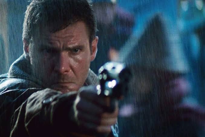 Harrison Ford as Rick Deckard, pointing a gun in Blade Runner