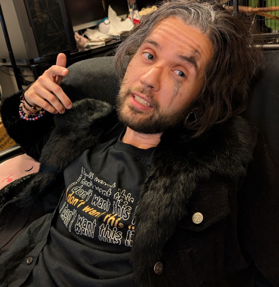 Photo of the person talking with his hand lifted.