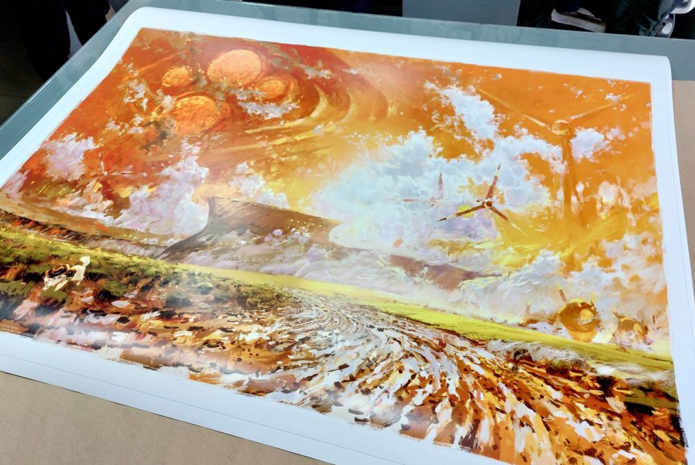 A large print of "The Golden Hour" on the print shop table.