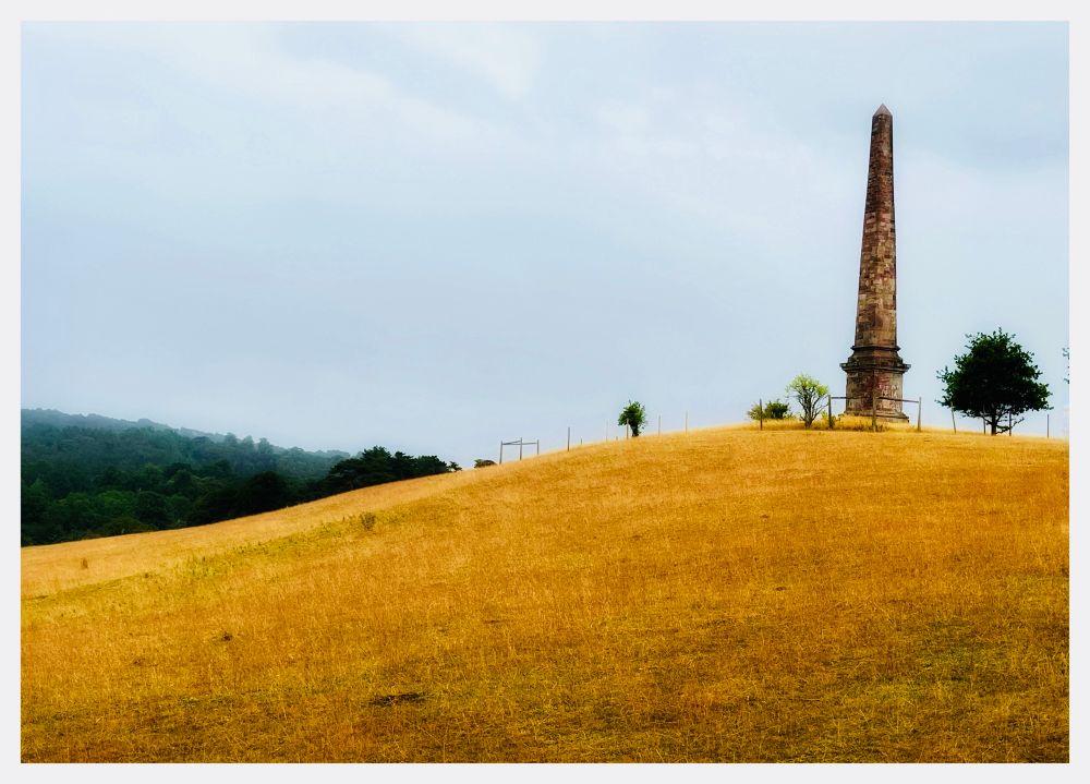 The Wychbury Obelisk, Hagley, Worcestershire, UK.  The obelisk, which stands on Wychbury Hill, is a local landmark that can be seen for miles around. Since at least the 1970s the monument has been defaced with  graffiti asking "Who put Bella in the Wych Elm?", a reference to an unsolved World War II-era mystery in which the decomposed body of a woman was found in a nearby wood. In 1944, four teenage boys discovered the remains of a woman inside a hollow Wych Elm tree. The identity of the woman has never been discovered and her murder remains unsolved although many theories have been put forward over the years. The graffiti serves as a reminder of this ‘murder most foul’.