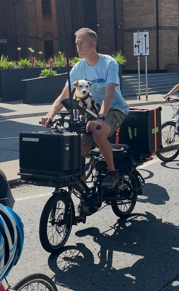 Hamish and his wee dog on a bike with big speakers.