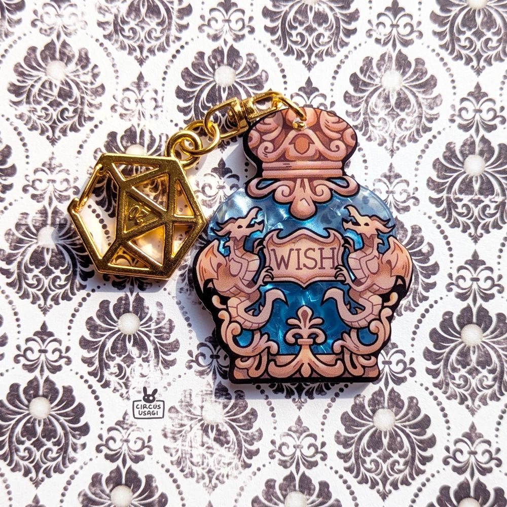 Acrylic charm of an ornamental bottle with gold dragons and a light blue porcelain gloss. The label reads 'Wish'. A D20 keyring is attached.