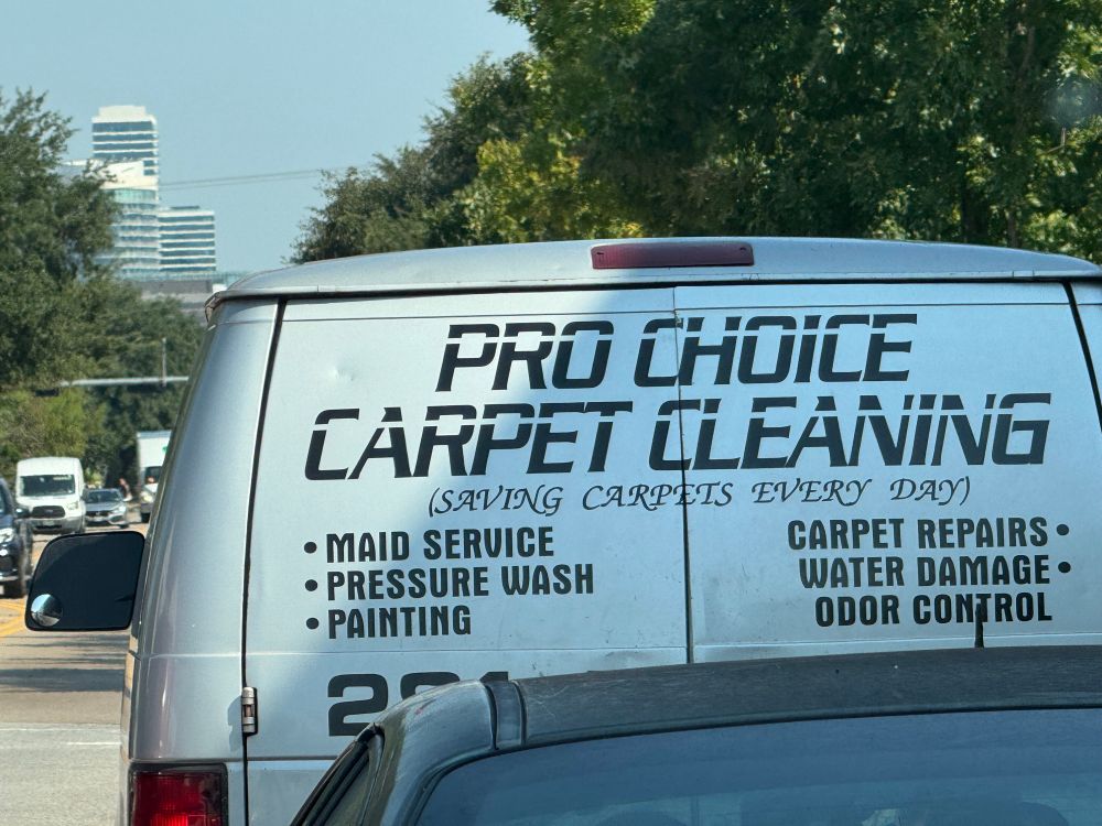 Van that says PRO CHOILE
CARPET CLEANING on the back in traffic 