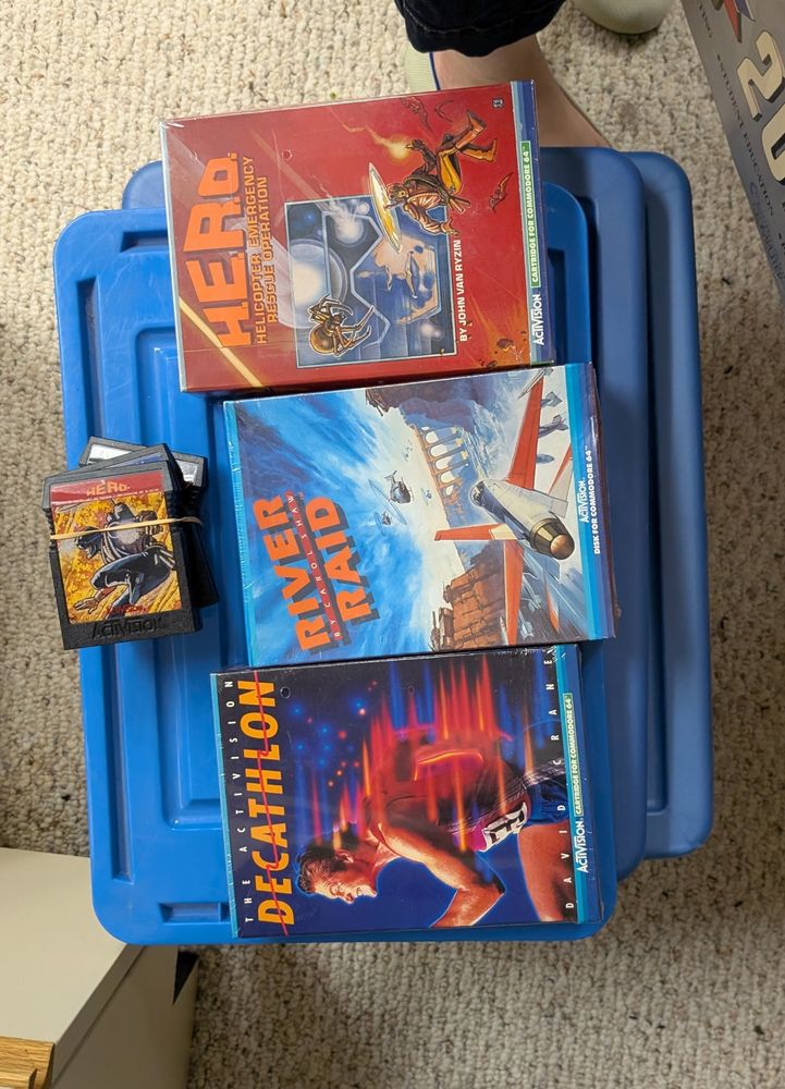 Three sealed boxes of games: Decathlon, River Raid and Hero. Then a mystery: unboxed Decathlon, Hero and a third game. 
