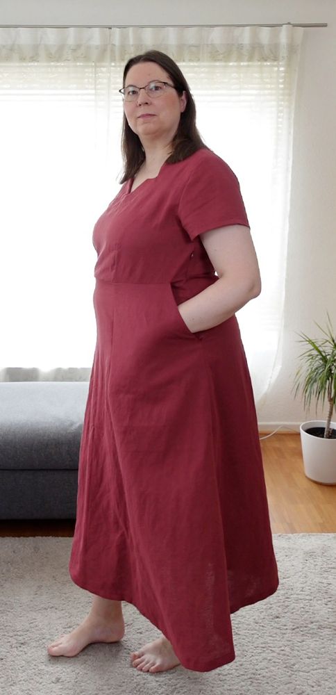 Woman in a red dress with her hand in the large pockets