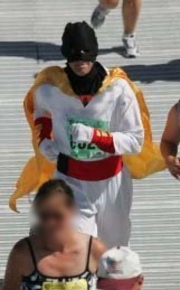 Me dressed as Space Ghost running with my race number pinned to my chest.