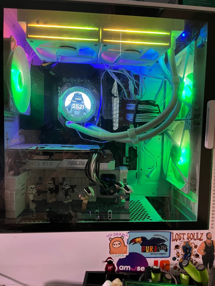 A photo of a computer build in progress featuring a Lego Star Wars diorama underneath the graphics card. The computer case is starting to become stickerbombed 