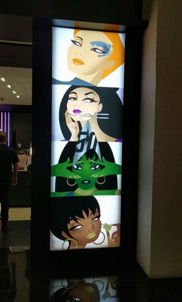 Photo of a backlit panel advertising MAC cosmetics Star Trek collection. It's a vertical stack of stylized portraits of Star Trek ladies. From top to bottom:
Seven of Nine
Deanna Troi
Orion Slave Girl (sorry if you have a name I am not remembering, ma'am)
Lt. Uhura