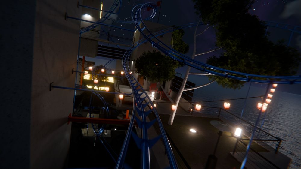 A still frame from the roller coaster animation I released a few months ago, but this time, it's night. A roller coaster rail twists through a modern house complex high over the sea. A patio with chairs, heat lamps, and a grill are ahead, along with a large tree. Lanterns and hanging lights light up the area. Stars can be seen through the clouds above.