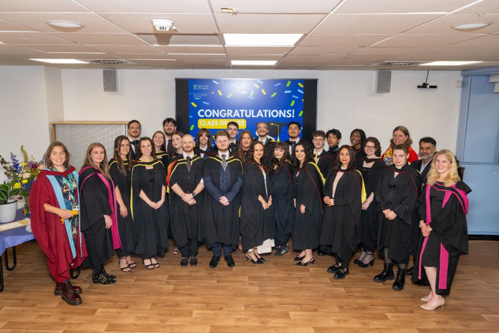 Class of 2025 stood together in graduation robes with Director of Education Olwyn Byron (left) and other academics in the Sir Graeme Davies Building common room.