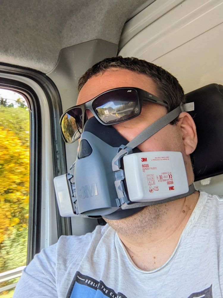 respirator with style and sun goggles sitting in a van