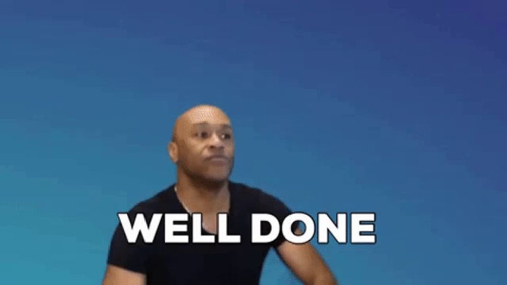 a bald man in a black shirt is clapping his hands and saying well done .