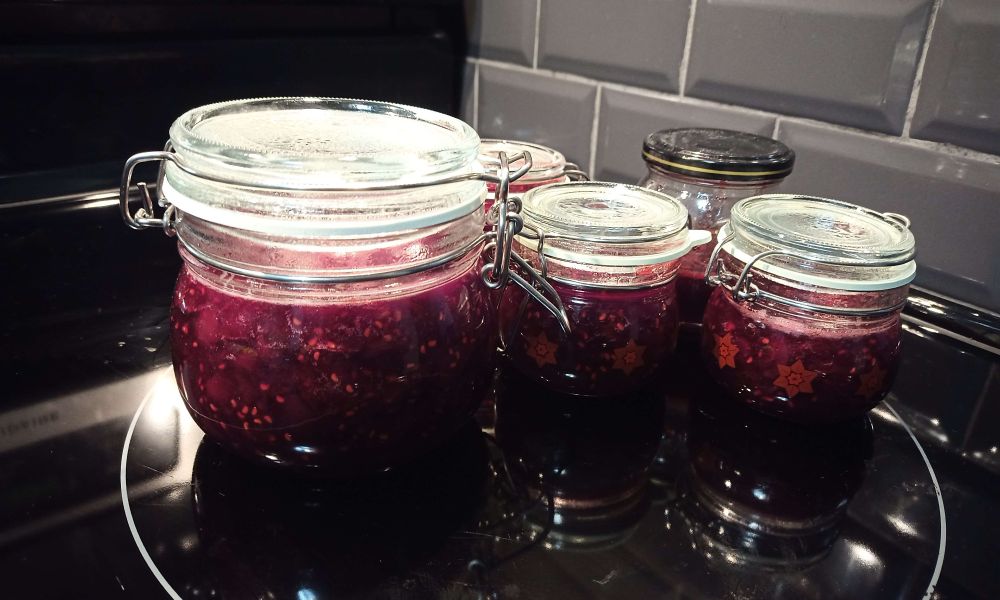 Several jars full of a dark red jam.