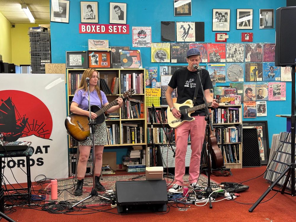 Heather and Tom of the band “Warm Regards” playing at the back of Slow Boat record shop.