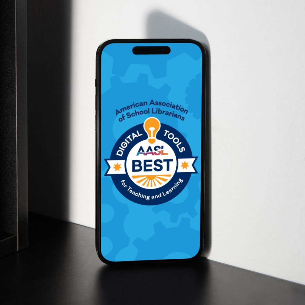 A smartphone displaying the logo of the American Association of School Librarians on its screen, with text "Digital Tools for Best Teaching and Learning". The device is placed on a surface with sunlight casting shadows nearby.