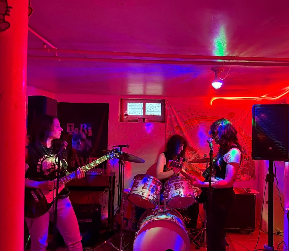 a three piece rock band getting ready to play music