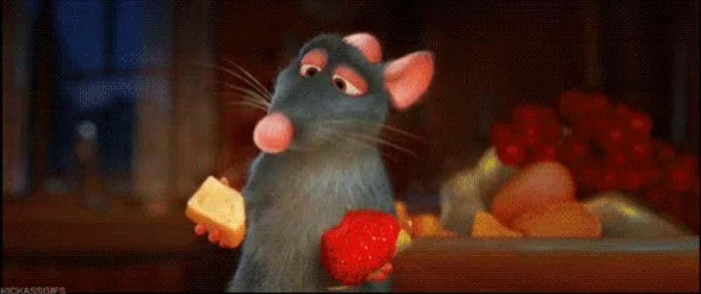 a cartoon rat is holding a strawberry and a piece of cheese