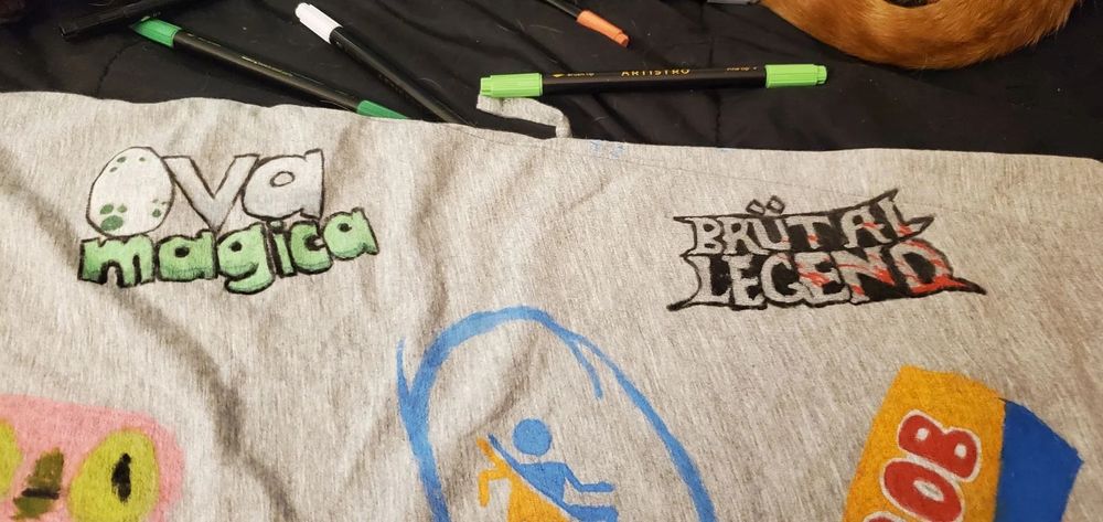 Ova Magical, Brutal Legend, and other gaming logos on fabric. 