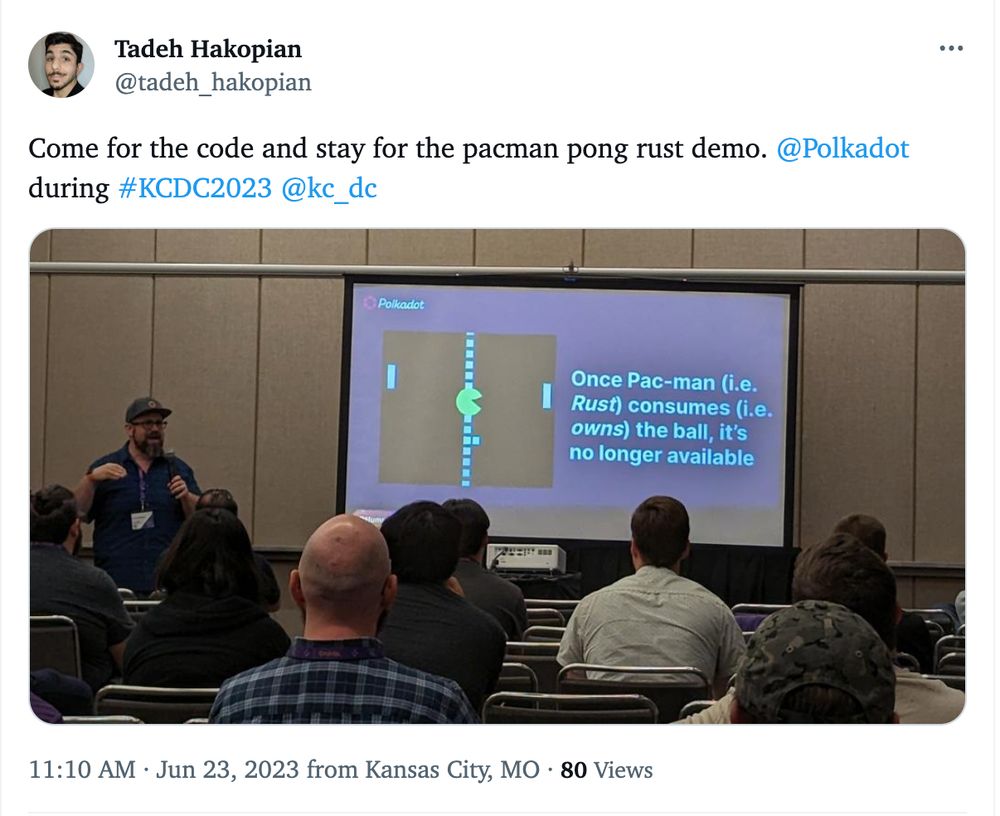 Screenshot of a tweet with a picture of me presenting in front of a screen showing a visualization of Pac-man eating a ball and the tweet said:

"Come for the code and stay for the pacman pong rust demo. 
@Polkadot
 during #KCDC2023 
@kc_dc"