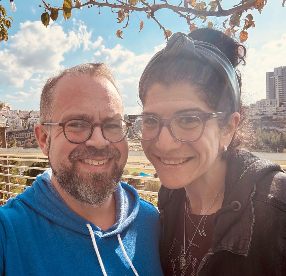 Two people outside posing for a picture after a nice lunch 