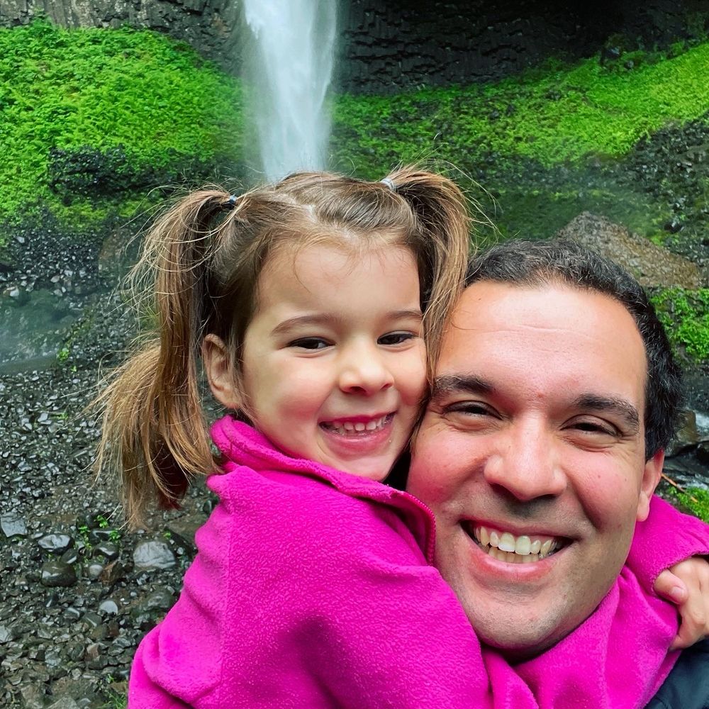 Léa and Luke Fritz smiling at the base of the waterfall. 