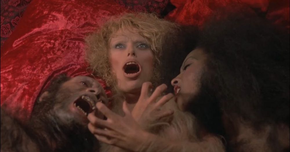 Stirba (Sybil Danning) transforms into a werewlf on a bed with two other werewolves in Howling II: Your Sister Is a Werewolf (1986)