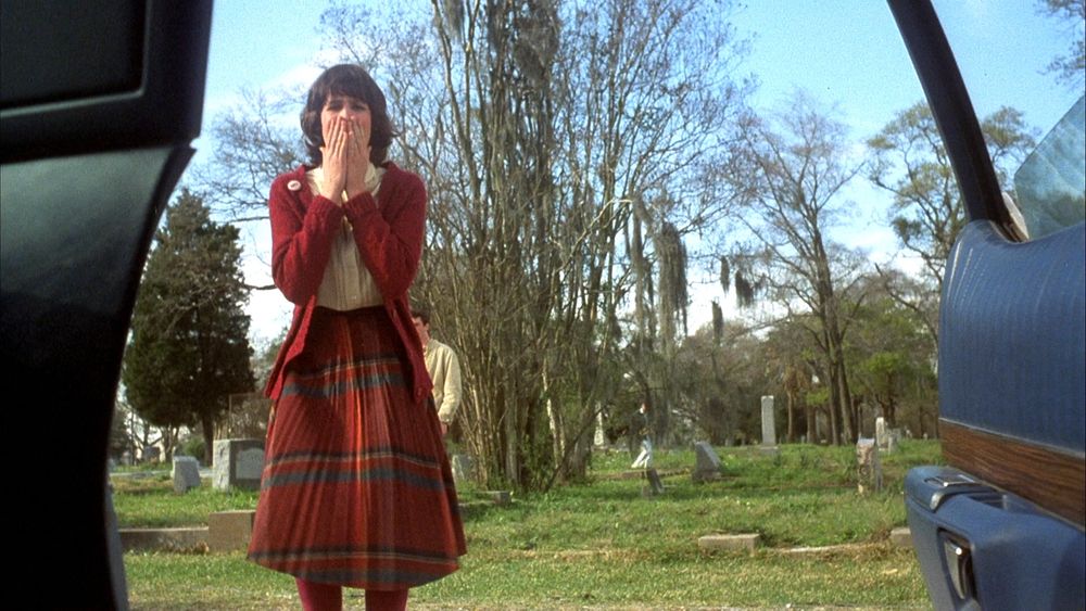A high school student stares in horror into a car in Student Bodies (1981)