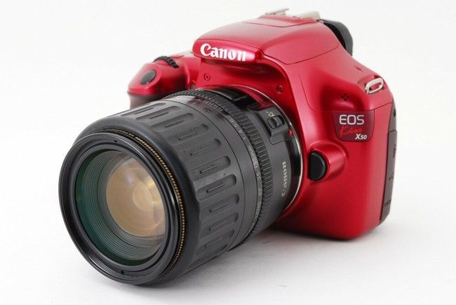 canon eos rebel with a red body. 