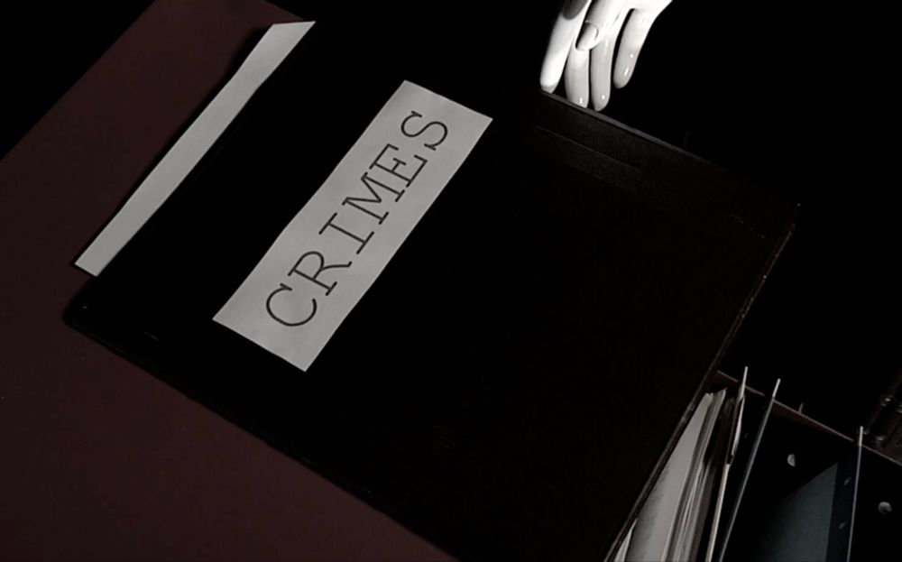 folder labeled CRIMES sitting on top of a filing cabinet