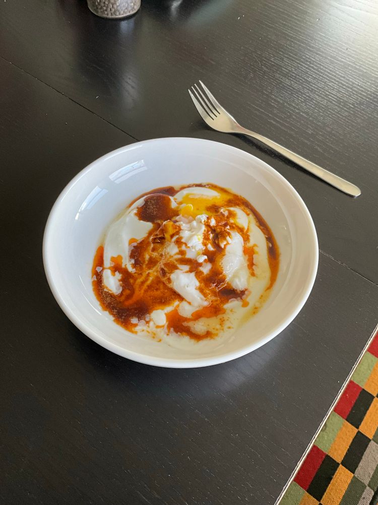 Garlic and salt Greek yogurt base, topped with a pouched egg, and a butter and paprika sauce. Not visible in the picture is some toast I made from some homemade bread.