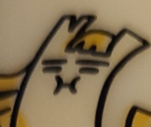 Detail of the "cheese horse" brand mascot's face, which bears a remarkable resemblance to the "nauseous" emoji.