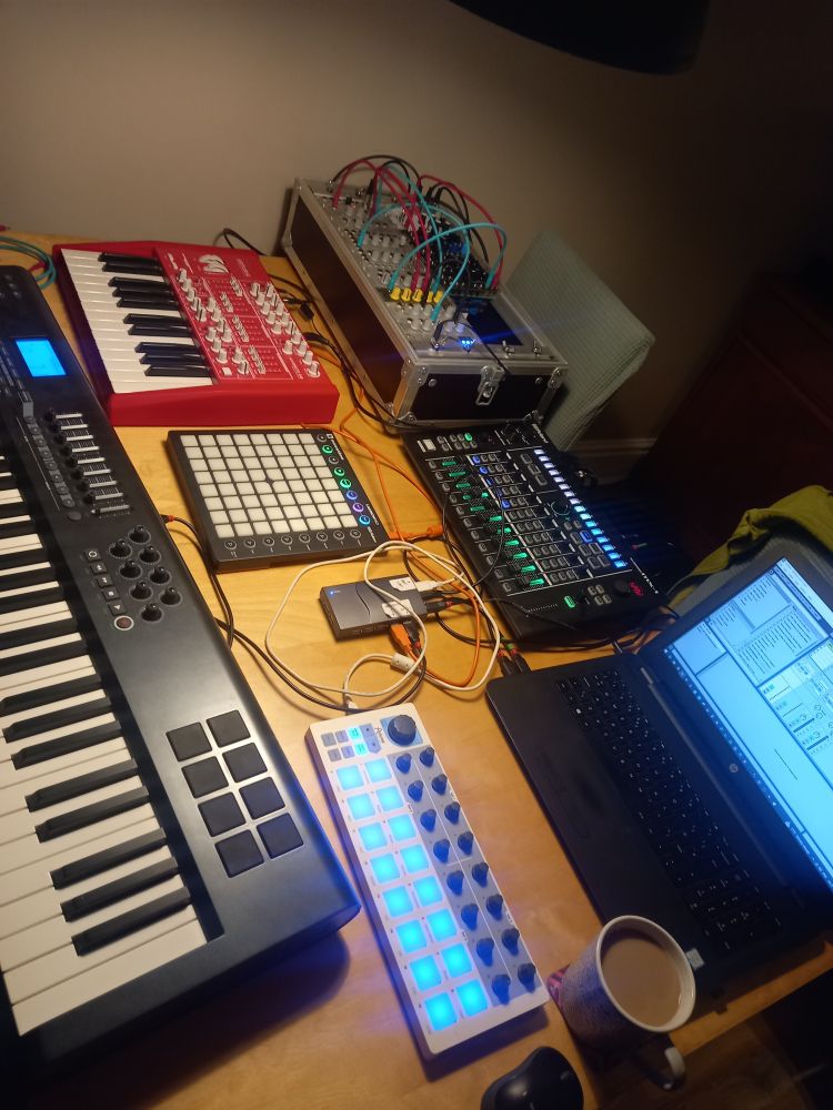 A table covered in synthesizers'n'stuff