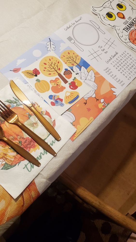 Table placemat with utensils with a Thanksgiving theme and fun activities on it