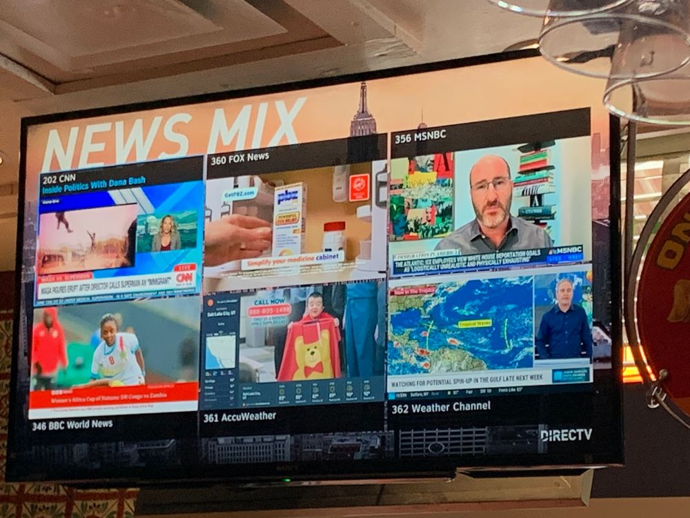 A television labeled news mix with six different news channels in small tiles next to each other filling the screen.