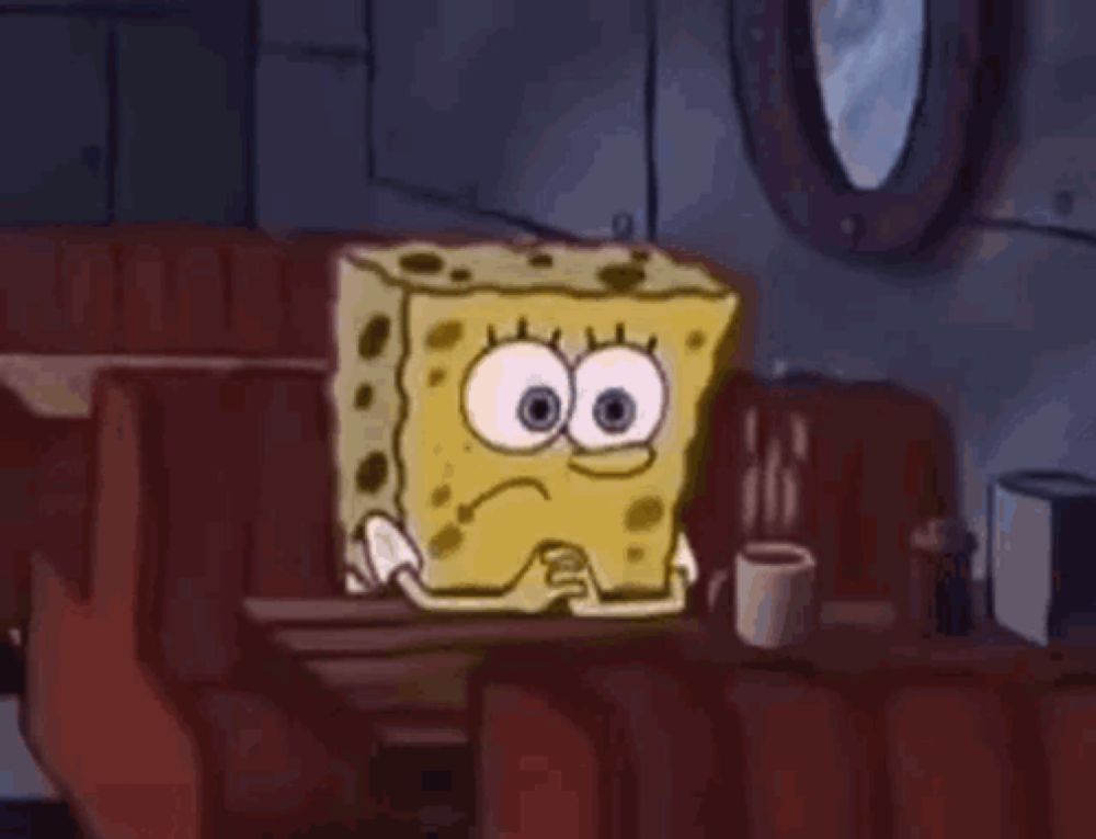 spongebob is sitting at a table in a diner with a cup of coffee .