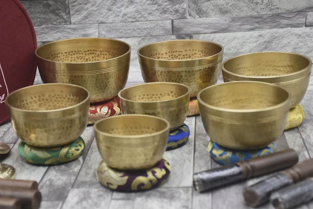 Set of 7 singing bowls of various sizes used in meditation practice. 