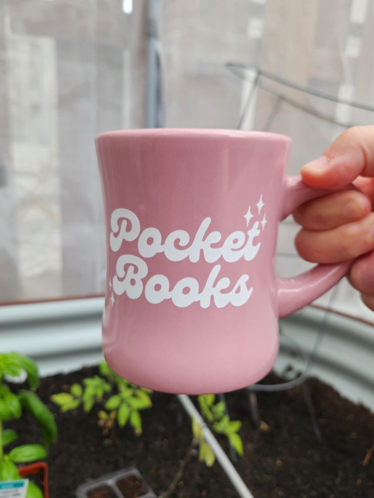 A pink diner mug that says Pocket Books, from the bookstore of the same name in Lancaster, PA.