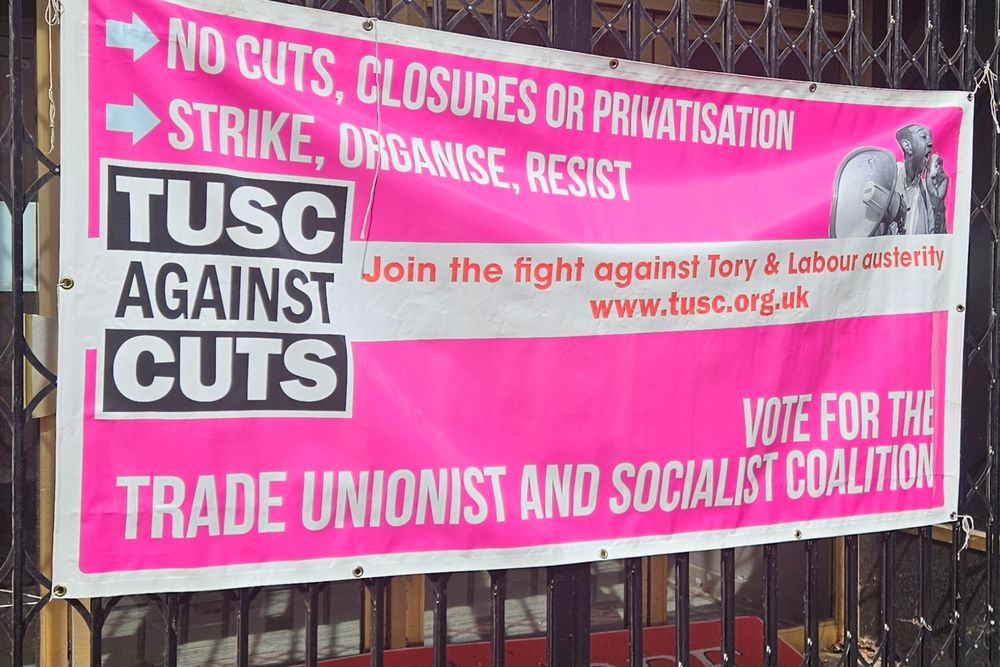 A pink banner with the words: no cuts, closures or privatisation. Strike, organise, resist. TUSC Against Cuts. Join the fight against Tory & Labour austerity. www.tusc.org.uk. vote for Trade Unionist and Socialist Coalition.