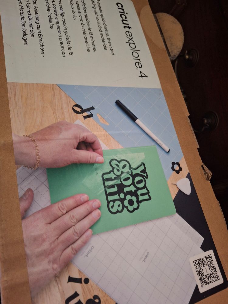 A photograph of the box for a Cricut Explore 4 die-cutting machine, which cuts flat materials such as vinyl and paper into custom shapes.