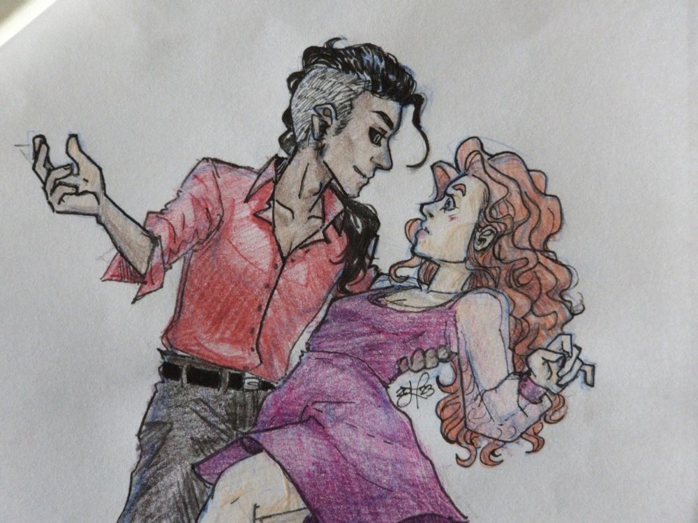 A redhead woman and mocha coloured man dancing - the redhead surprised and he lightly dipped her whilst dancing. She's wearing a purple dress that's flowing and he's wearing a red dress shirt black pants.